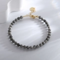 Minimalist grey marble bead bracelet featuring gold clasp and circular charm detail - Map Stone Bracelet