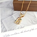 Detailed shot of golden letter B pendant with colorful zircon stones and box chain necklace - Letter B