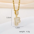 Detailed macro view of 18k gold plated letter F pendant with zircon stones and rope chain - Letter F Pendant Necklace / Gold