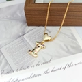 Macro shot of gold heart buckle and letter I pendant with colorful cubic zirconia stones - Letter I
