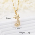 Macro detail of 18k gold plated crown letter J pendant with micro-pave cubic zirconia - Gold J