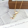 Close-up of golden letter J pendant with vibrant colorful crystals and heart clasp - Letter J