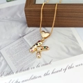 Detailed close-up of a golden heart necklace with a multicolor zircon letter K pendant - Letter K