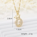 Macro view of crown letter O pendant with cubic zirconia and 18k gold plating - Crown Letter O Necklace / Gold