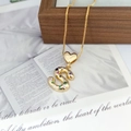 Detailed view of a gold S-letter heart pendant with multi-colored gemstones and chain - S