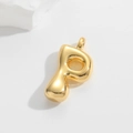 Macro shot of 3D bubble letter P pendant with polished gold finish on white background - Letter P