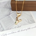 Detail of gold letter Y necklace pendant with colorful cubic zirconia on a wooden surface - Pendant + Box Chain / Letter Y