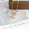 Detailed macro view of gold letter Z pendant featuring vibrant multi-colored gemstones - Letter Z