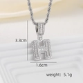 Macro detail of silver-toned H letter pendant with baguette cut cubic zirconia stones - H Style - Silver (Pendant And Rope Chain)