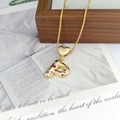 Detail of a golden bubble letter P pendant with colorful zircon stones on a heart clasp - Letter P