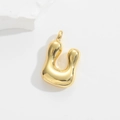 Close-up of golden letter U bubble pendant with high-polished metallic glossy finish - Letter U