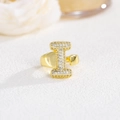 Detailed macro view of gold letter I ring paved with white sparkling zircon stones - Letter I