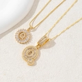 Gold plated letter Q pendant necklace with clear zircon stones on a white background - Letter Q