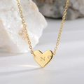 Elegant gold heart pendant necklace featuring the engraved letter N on a fine link chain - Letter N