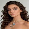 Close-up of silver necklace with crystal letter Q and blue square gemstone pendant - Silver Q
