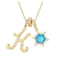 Close-up of golden letter K pendant with clear zircons and starburst blue stone necklace - Gold - Letter K