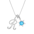 Close-up of 18K gold letter R pendant with snowflake charm and blue center stone - Silver-Letter R