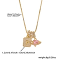 Macro shot of gold box chain with cubic zirconia letter P, Saturn and ring charms - Box Chain / Gold P