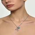 Close-up of a silver letter pendant necklace with a teardrop blue stone on the collarbone - Silver G