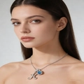 Silver letter K necklace with blue zircon pendant on model, luxury jewelry piece - Silver K