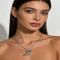 Silver letter M pendant necklace featuring a blue gemstone with pavé diamond accents - Silver M