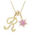 Close-up of gold necklace with pavé letter R and snowflake pendant with pink stone - Box Chain / Gold R