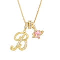 Detail of gold necklace featuring letter B pendant with pink heart Saturn design - Letter B / Gold