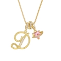 Close-up of gold letter D necklace with pink heart Saturn pendant and sparkling crystals - Letter D / Gold