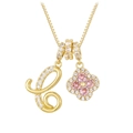 Macro shot of gold necklace with rhinestone letter C and pink clover pendants - Letter C / Gold