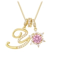 Macro detail of gold initial V necklace with pink gemstone flower and pavé zircons - Box Chain / Gold Y