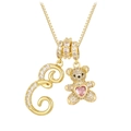Detail of gold bear pendant with pink heart stone and crystal paved letter E charm - Gold E