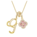 Close-up of golden box chain with zircon-studded letter g and pink clover pendant - Gold Letter G Style