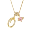Detailed shot of gold-plated necklace with letter Q pendant and pink heart Saturn charm - Letter Q / Gold