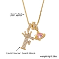 Close-up of golden crown letter F necklace with pink crystal planet pendant dimensions - Gold Letter F Style