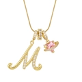 Macro shot of gold letter M pendant with pink heart planet and sparkling zircon stones - Letter M Heart Planet Necklace (With Stainless Steel Snake Chain) / Gold