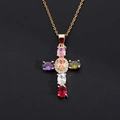 Macro shot of gold cross necklace with six colorful oval gemstones and micro-pave zircons - Colorful