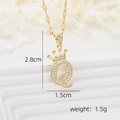 Detailed view of crown letter Q pendant with dimensions 2.8cm by 1.5cm in gold finish - Gold Q
