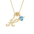Close-up of golden letter H pendant with blue heart crystal and sparkling zircon stones - Gold H