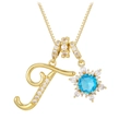Macro shot of gold letter F pendant with blue zircon snowflake detail and fine chain - Gold - Letter T