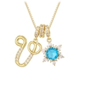 Detailed shot of golden necklace with blue zircon snowflake and crystal letter pendants - Gold - Letter V