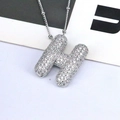 Macro shot of silver-colored bubble letter H pendant with micro-pave cubic zirconia stones - Letter H Style
