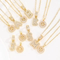 Gold plated initial pendant necklaces with iced-out cubic zirconia letter charms - Letter A / Baguette And Flower Combo