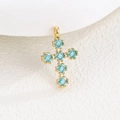 Macro shot of gold cross pendant with six square blue zircons and fine claw settings - Pendant Only (Without Chain) / Aquamarine (March)