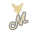 Detailed macro view of a gold butterfly pendant with blue and white crystals on letter M - Letter M Style