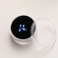 Detailed macro view of marquis and round blue crystal dental jewelry set in a round case - Large / Blue