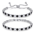 Set di bracciali tennis color argento con zirconi neri e bianchi su sfondo bianco - Set di bracciali / Nero E Bianco