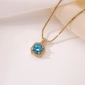 Macro shot of gold perfume bottle pendant with blue zircon and sparkling crystals - Pendant Only / Sapphire Blue