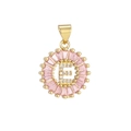 Macro detail of round letter E pendant with pink zircon border and gold plating - Gold E