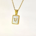 Detailed macro view of Taurus constellation necklace with gold rectangular shell pendant - Taurus