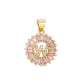 Macro detail of gold-plated pendant with letter W, pink zircon halo, and pavé setting - Gold W
